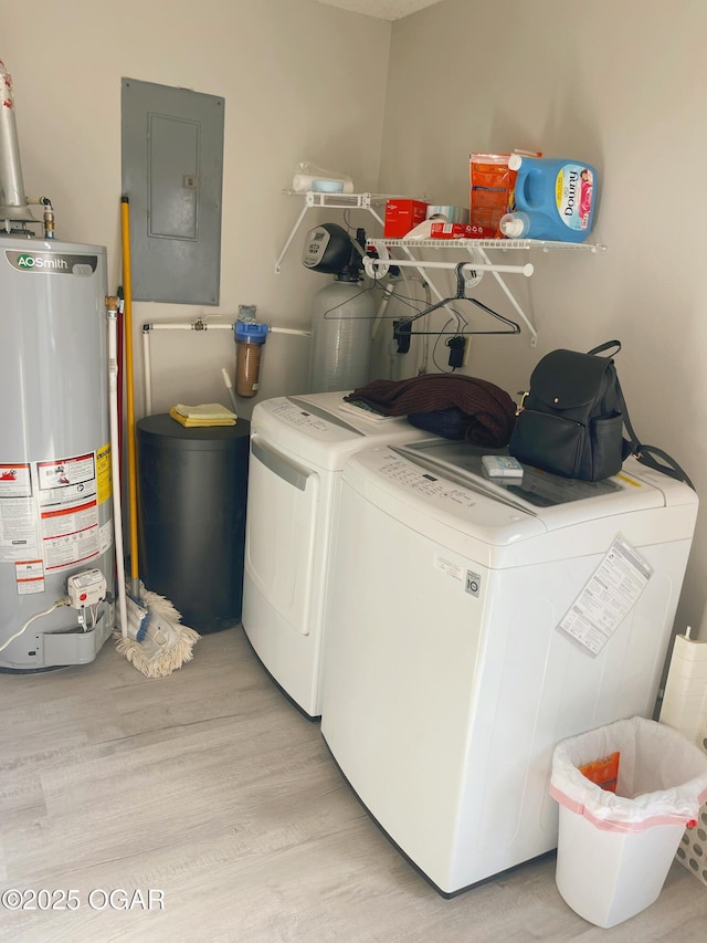 laundry room with light wood finished floors, water heater, laundry area, electric panel, and independent washer and dryer