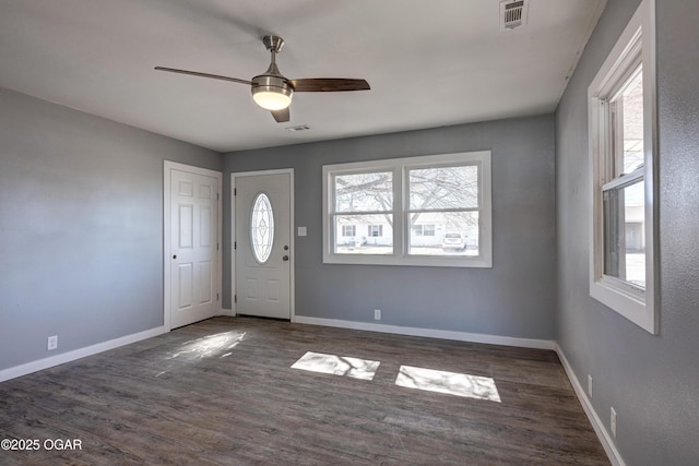 foyer entrance with visible vents, baseboards, and wood finished floors