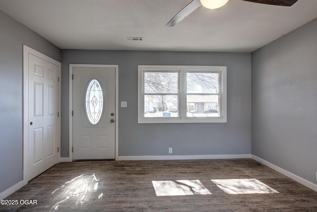 foyer entrance featuring wood finished floors, visible vents, and baseboards