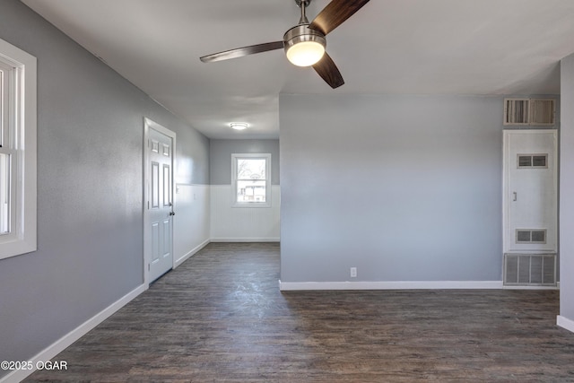 empty room with visible vents and dark wood-style flooring