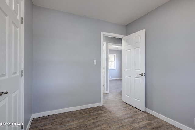 empty room with wood finished floors and baseboards