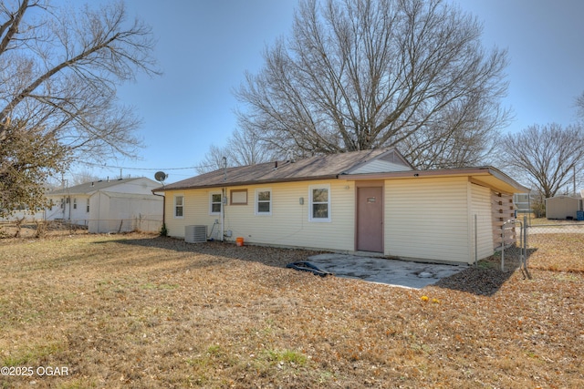 rear view of property with a patio, fence, a lawn, and central AC unit