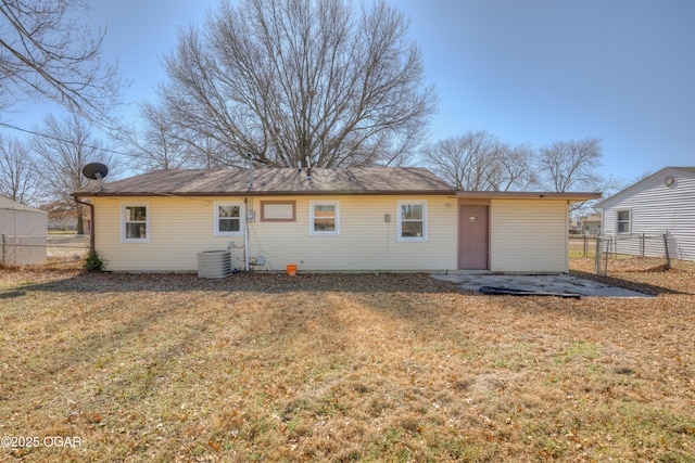 back of house featuring fence, cooling unit, and a yard