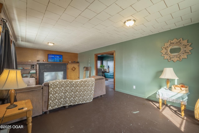 living room with concrete floors and baseboards