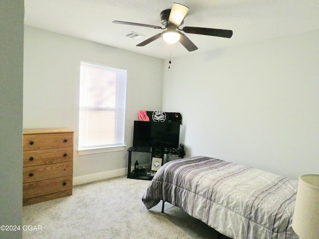 bedroom with carpet floors, a ceiling fan, visible vents, and baseboards