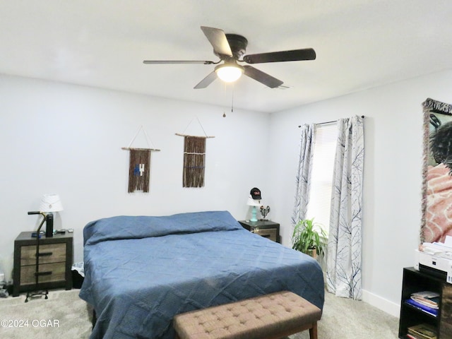 carpeted bedroom with a ceiling fan and baseboards