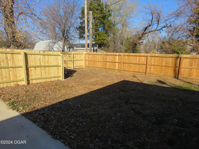 view of yard with a fenced backyard