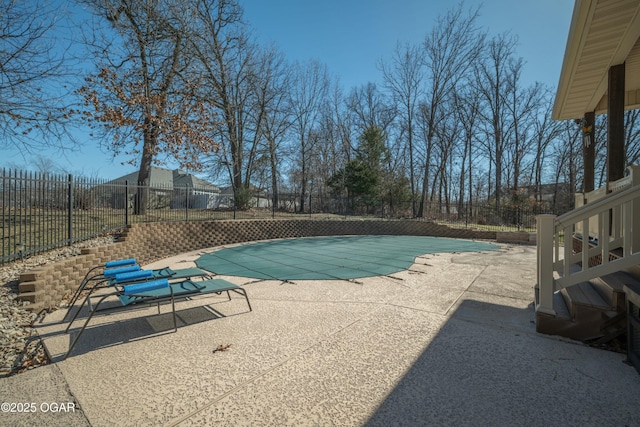 view of swimming pool featuring a fenced backyard, a fenced in pool, and a patio