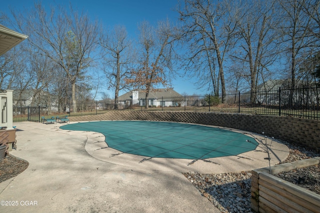 view of swimming pool with a patio area, fence, and a fenced in pool