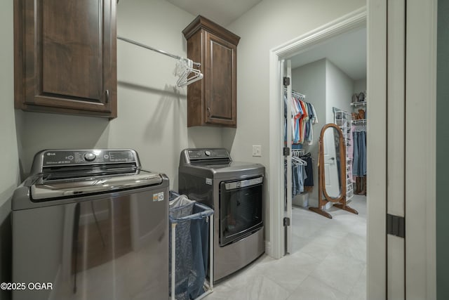 laundry room featuring cabinet space and washing machine and dryer