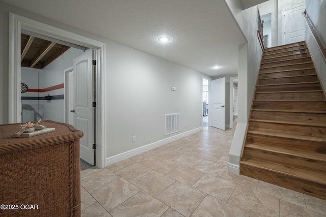 corridor featuring visible vents, a textured ceiling, recessed lighting, stairway, and baseboards