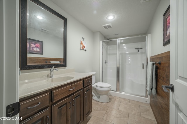 bathroom featuring visible vents, a textured ceiling, a shower stall, tile patterned flooring, and vanity