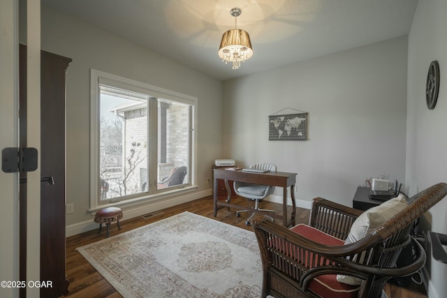 office space with visible vents, baseboards, an inviting chandelier, and dark wood-style flooring