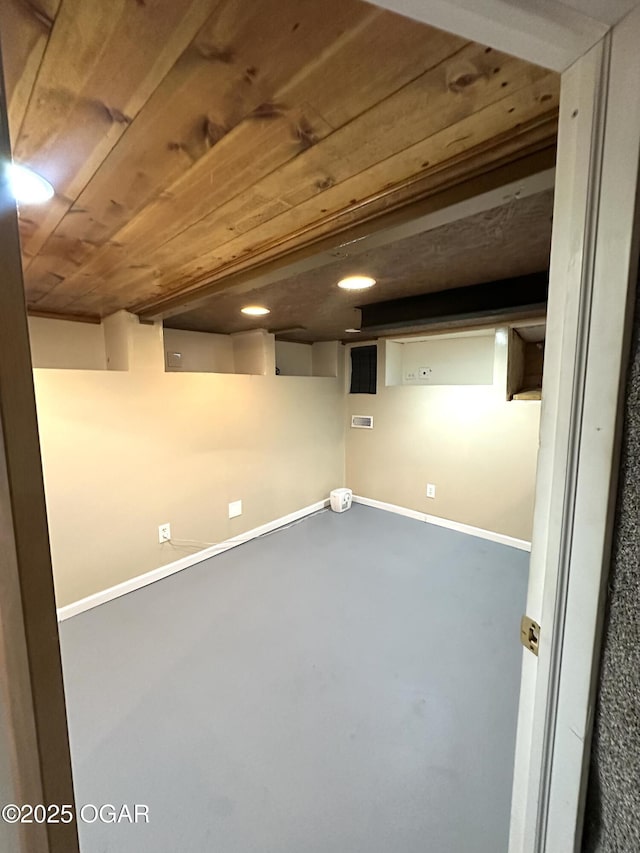 finished basement with wooden ceiling and baseboards