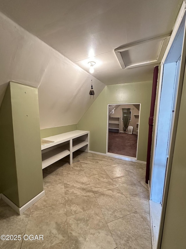 bonus room with vaulted ceiling and baseboards