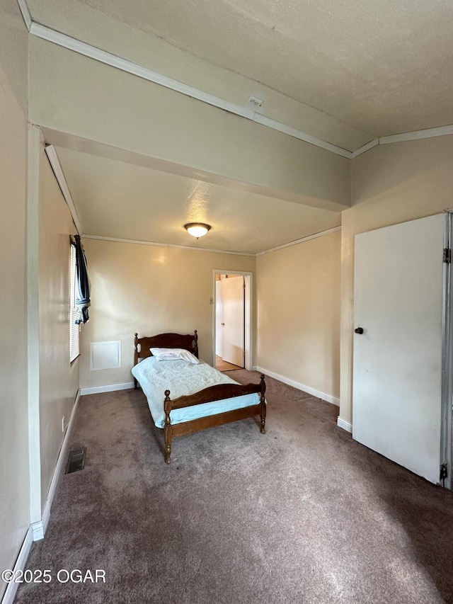 unfurnished bedroom with ornamental molding, baseboards, visible vents, and carpet flooring