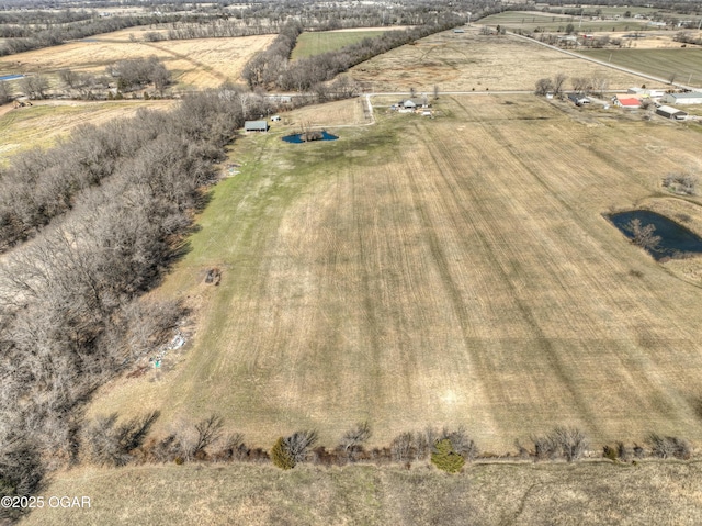 birds eye view of property with a rural view