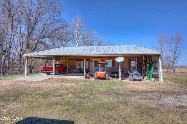 view of outdoor structure featuring driveway and a carport