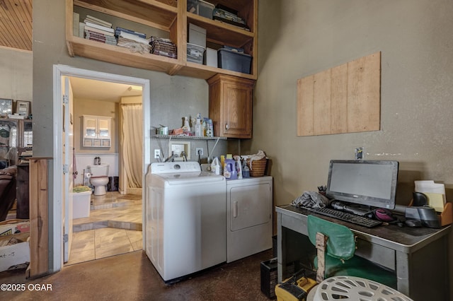 clothes washing area with cabinet space and separate washer and dryer