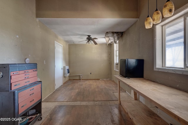 living room featuring heating unit, wood-type flooring, and ceiling fan