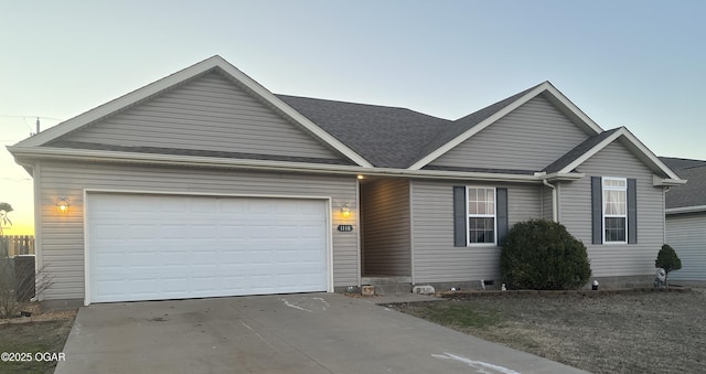 ranch-style home with a garage, driveway, and a shingled roof