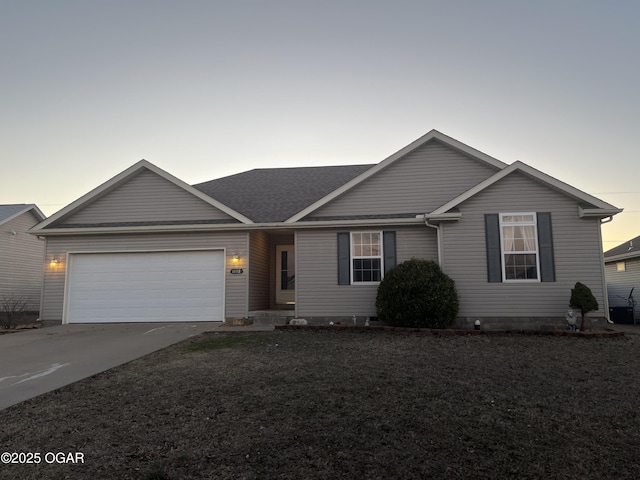 single story home with a garage, driveway, a yard, and a shingled roof