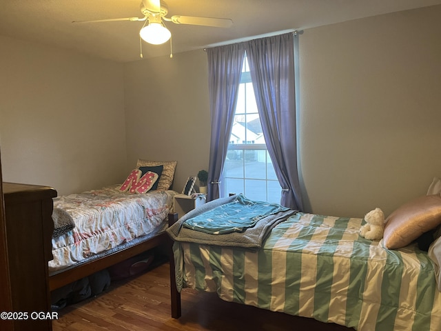 bedroom with ceiling fan and wood finished floors