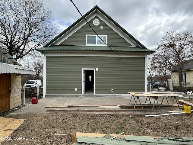 rear view of house featuring metal roof