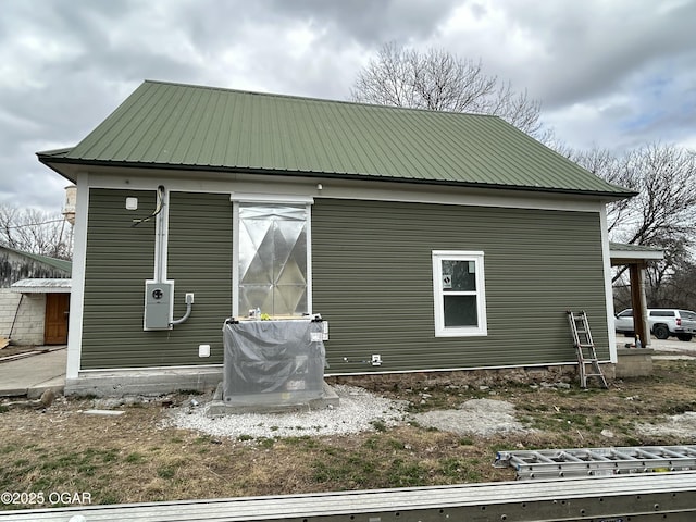 rear view of property featuring metal roof