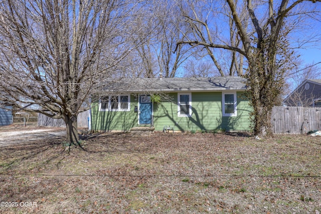 ranch-style home with fence