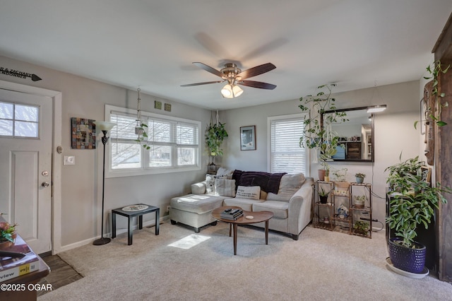 living area with carpet, visible vents, baseboards, and ceiling fan