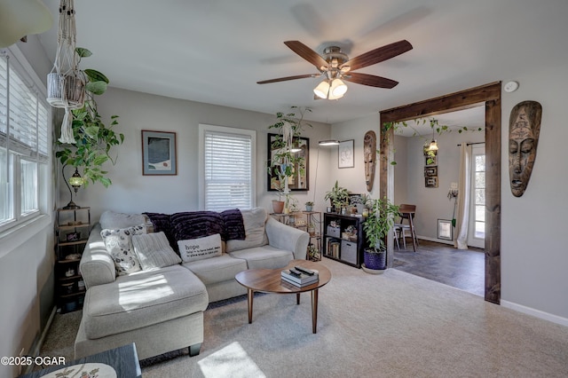 carpeted living room with plenty of natural light, baseboards, and ceiling fan