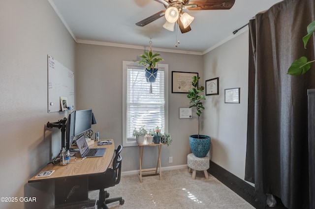 carpeted home office with baseboards, ornamental molding, and a ceiling fan