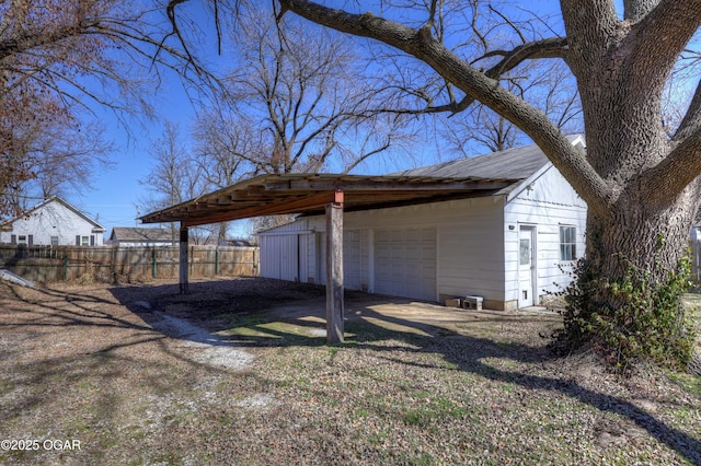 exterior space featuring an outdoor structure and fence