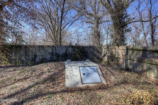 view of storm shelter with a fenced backyard