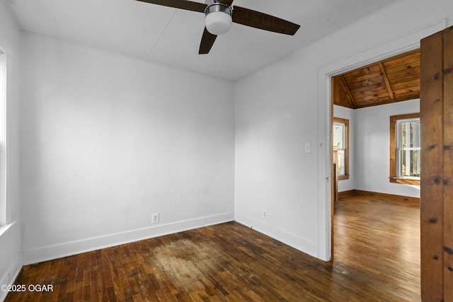 spare room featuring baseboards, a ceiling fan, wooden ceiling, hardwood / wood-style flooring, and vaulted ceiling