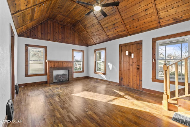 entryway featuring a fireplace with flush hearth, a wealth of natural light, and wood ceiling