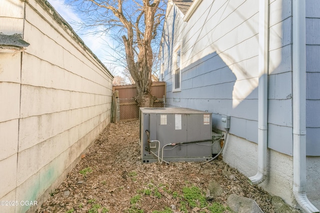 details featuring central AC unit and fence