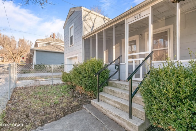 entrance to property with a garage and fence