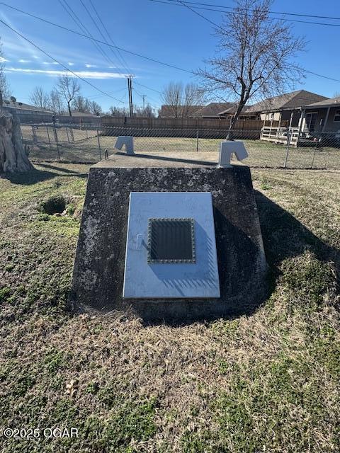 view of storm shelter featuring fence