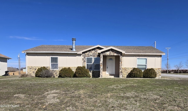 2831 E 19th St, Joplin, MO 64801 - view of front facade featuring board and batten siding, stone siding, roof with shingles, and a front lawn