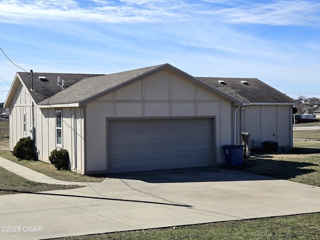 view of property exterior with a garage, roof with shingles, driveway, and board and batten siding