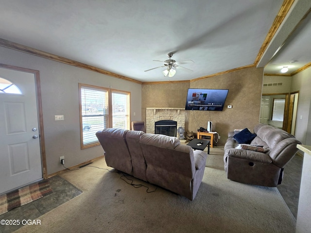 carpeted living room featuring a ceiling fan, baseboards, visible vents, a glass covered fireplace, and crown molding