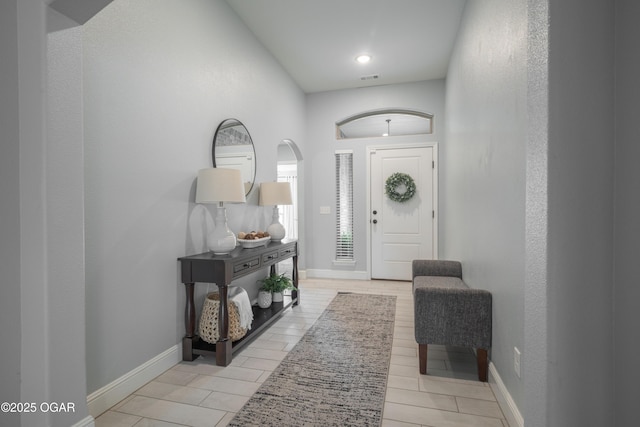 foyer entrance featuring visible vents and baseboards