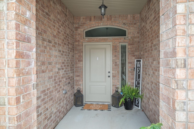 property entrance featuring brick siding