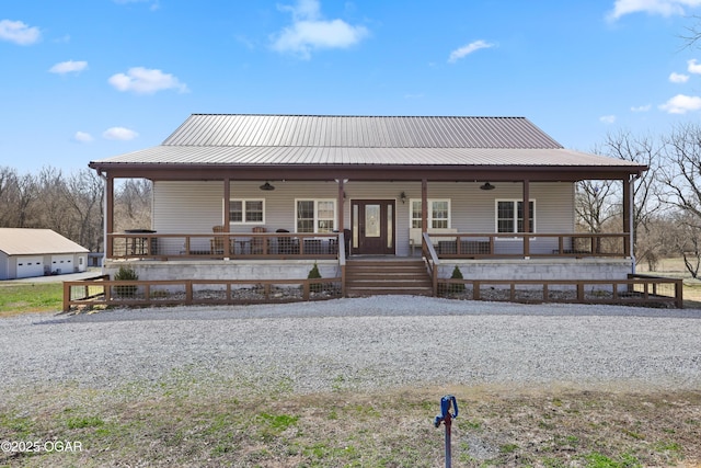 view of front of house featuring covered porch, metal roof, and a ceiling fan