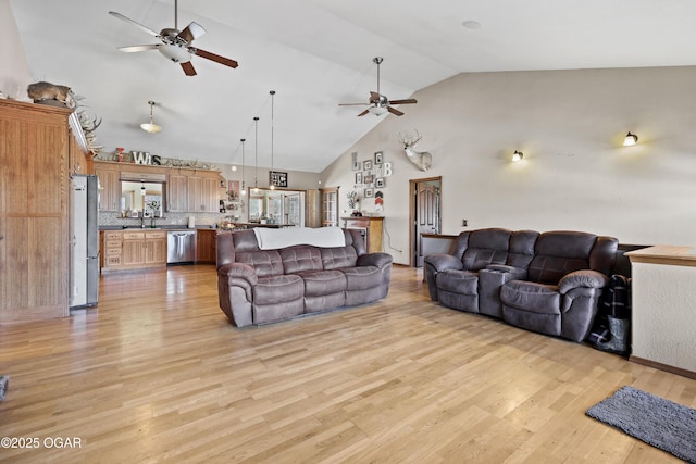 living room with light wood-style flooring, high vaulted ceiling, and ceiling fan