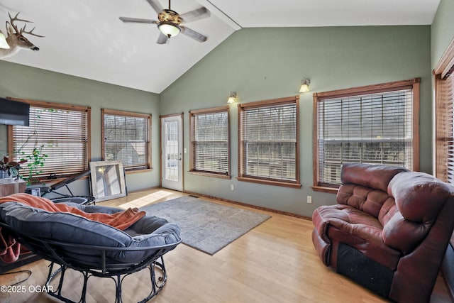 living room with high vaulted ceiling, wood finished floors, baseboards, and ceiling fan