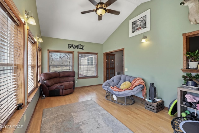 living area with wood finished floors, baseboards, visible vents, high vaulted ceiling, and ceiling fan