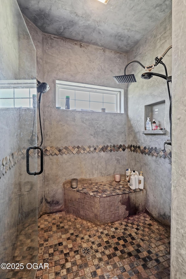 full bath featuring tiled shower and a healthy amount of sunlight